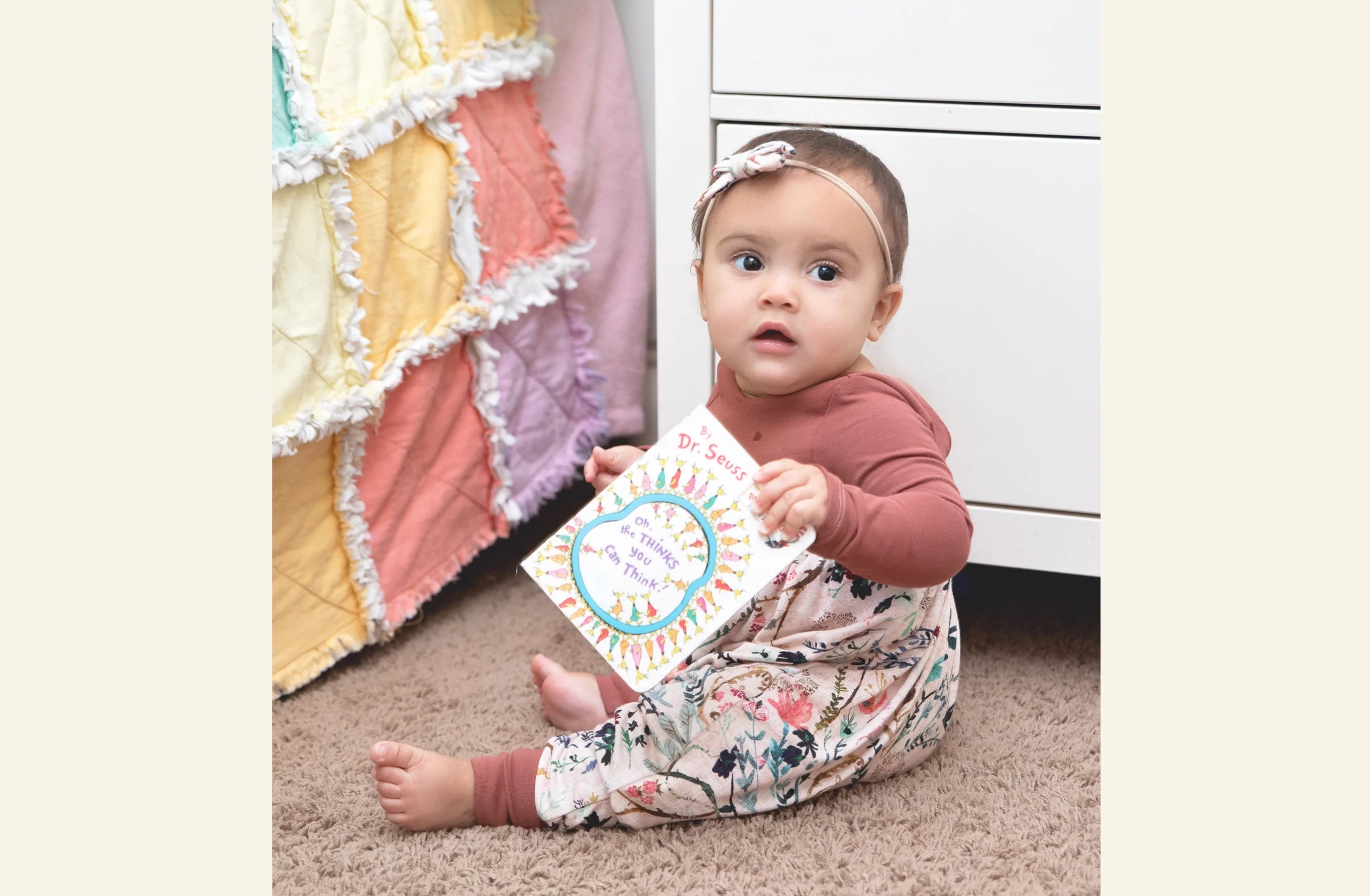 Baby on floor with a book