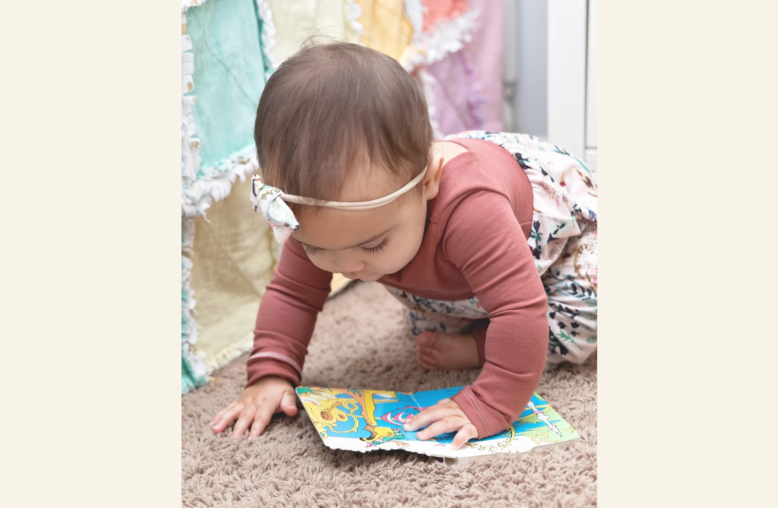 Baby bending to look at book