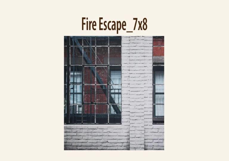Industrial building facade with large grid windows and a fire escape against red bricks.