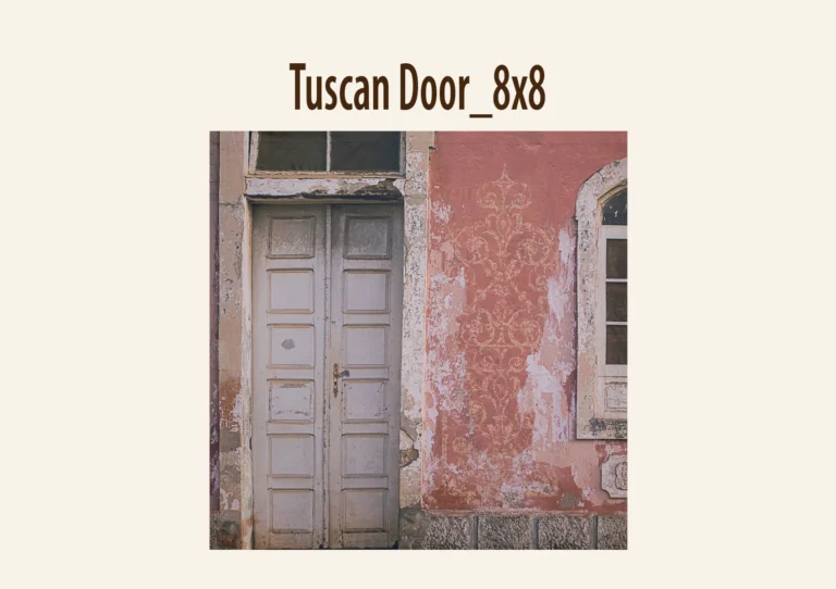 A weathered building facade with a white wooden door and faded red wall featuring an ornate floral pattern.
