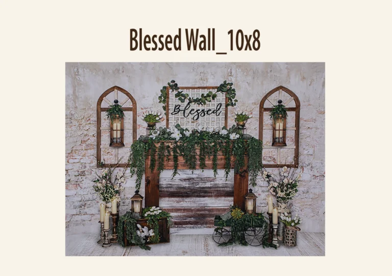 Rustic photography backdrop with a faux fireplace, greenery, and "Blessed" sign.