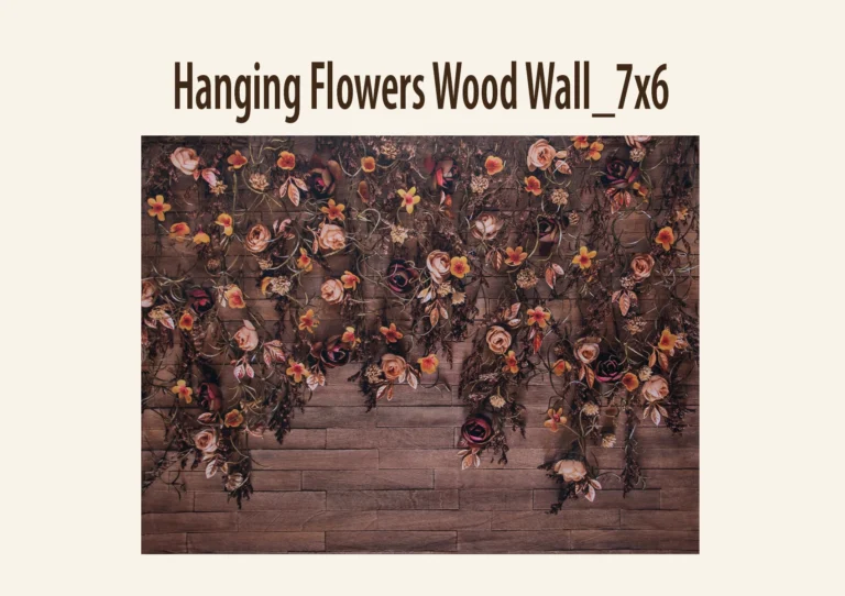 A floral photography backdrop with artificial flowers and foliage against a wooden-textured background.